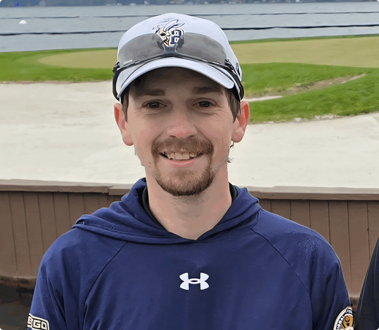 Man smiling outdoors in casual attire